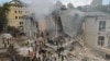 Ukrainians work at the site of a missile strike on a children's hospital in Kyiv on July 8.