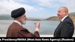 Iranian President Ebrahim Raisi and Azerbaijan's President Ilham Aliyev visit a dam on the Azerbaijan-Iran border, May 19, 2024.
