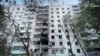 Firefighters and a police officer work at the site of an apartment building damaged during Russian strikes on Chernivtsi, Ukraine, July 12, 2025.