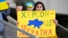 Українська вболівальниця з плакатом «Херсон – це Україна» перед матчем Ліги націй УЄФА між Україною і Вірменією. Лодзь, Польща, 11 червня 2022 року